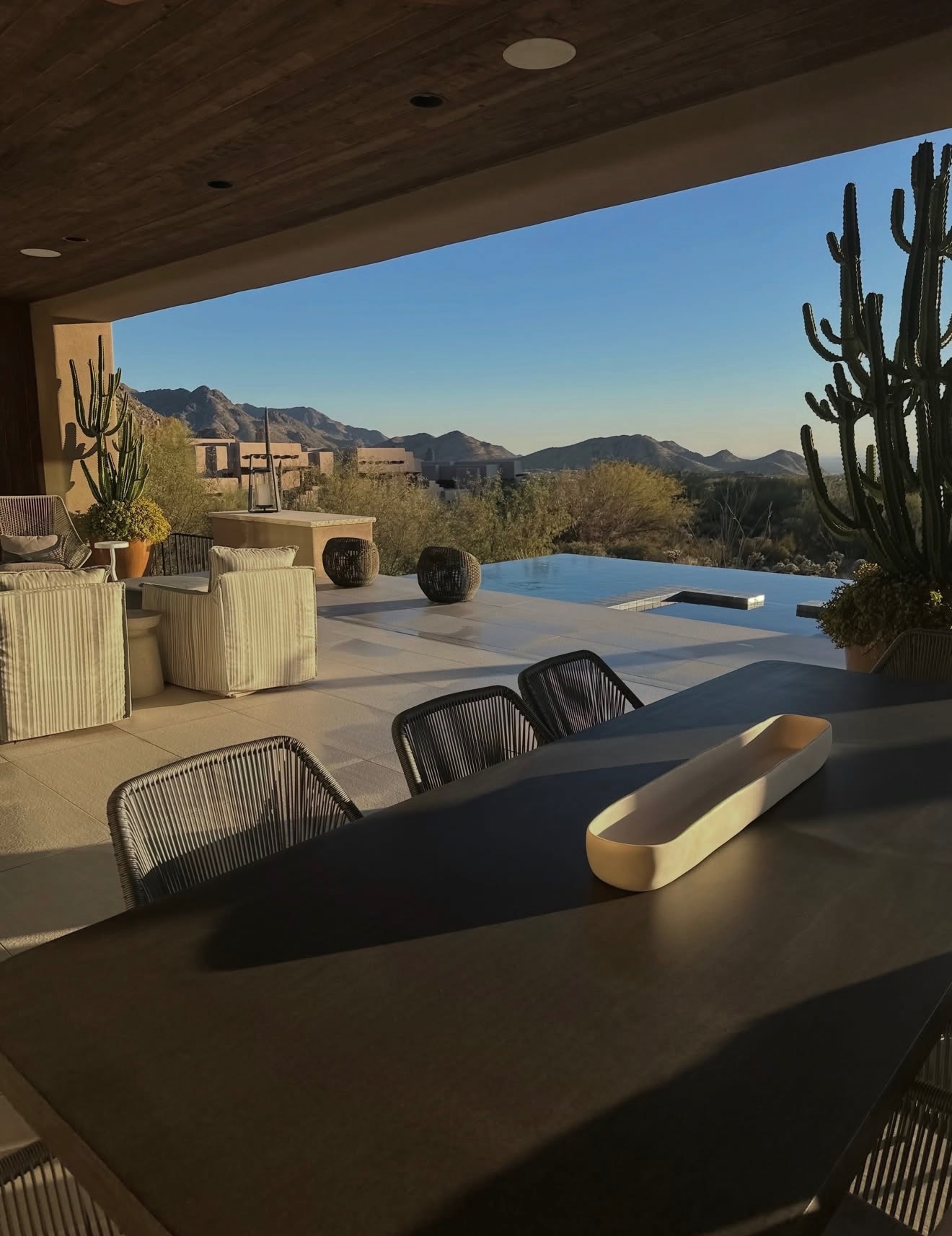 Luxury Arizona estate patio with infinity pool, desert mountains and saguaro cactus